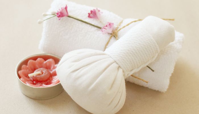 white Chilled Compressing bag with unlit candle by the side